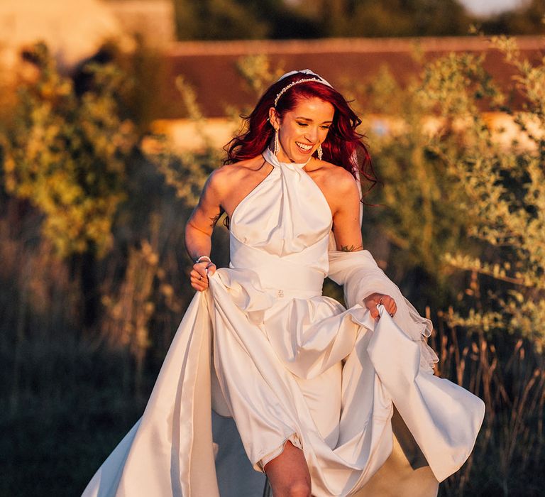 Bride wearing black wedding shoes by Manolo Blahnik in stunning halter neck wedding dress during golden hour 