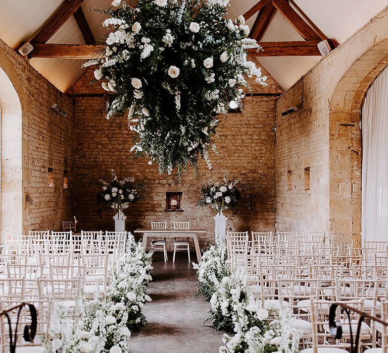 Lapstone Barn wedding venue in the Cotswolds with white wedding flowers and hanging installation 