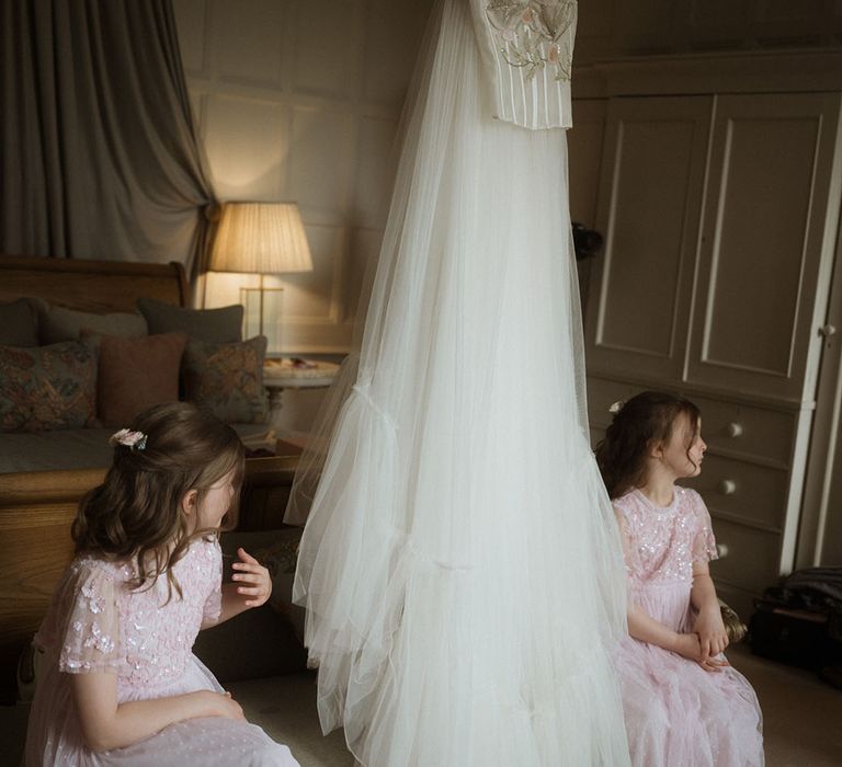 Bride's custom Bowen Dryden wedding dress with the two flower girls in pretty pink dresses 