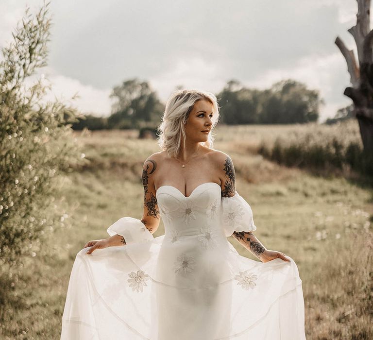 Bride with short blonde hair and tattoos in strapless wedding dress with detachable sleeves 