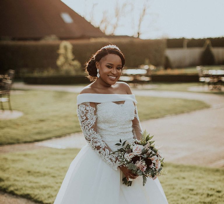 Bride in off the shoulder wedding dress with delicate illusion lace sleeves 