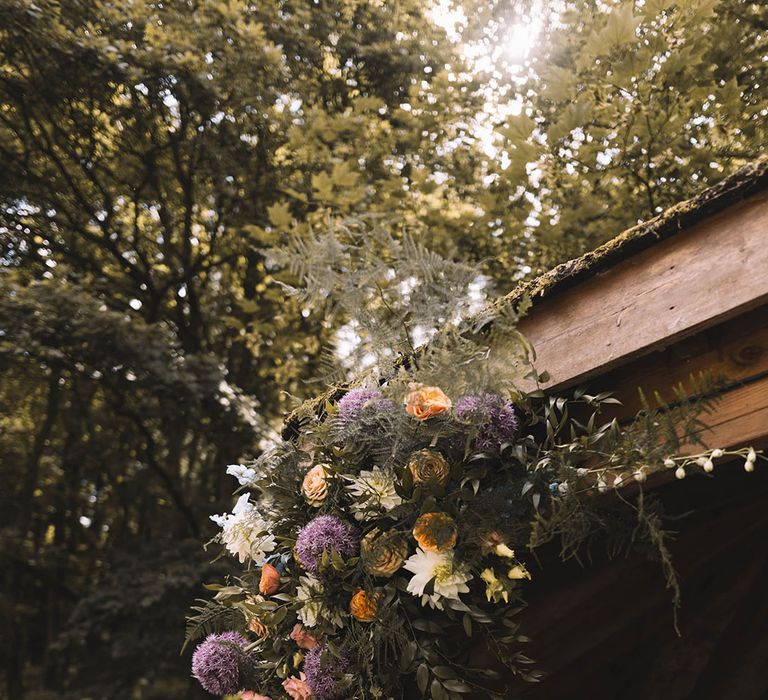 Orange and purple pastel wedding flower decorations for outdoor wedding at The Venue, Bowers Mill 