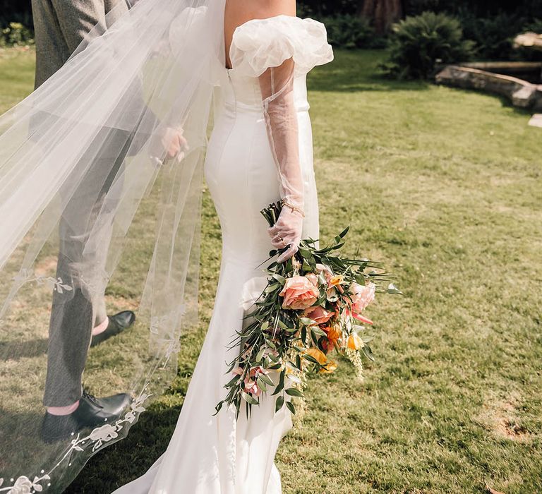 The bride walks around Wyresdale Park wedding venue in a puff sleeve wedding gown 