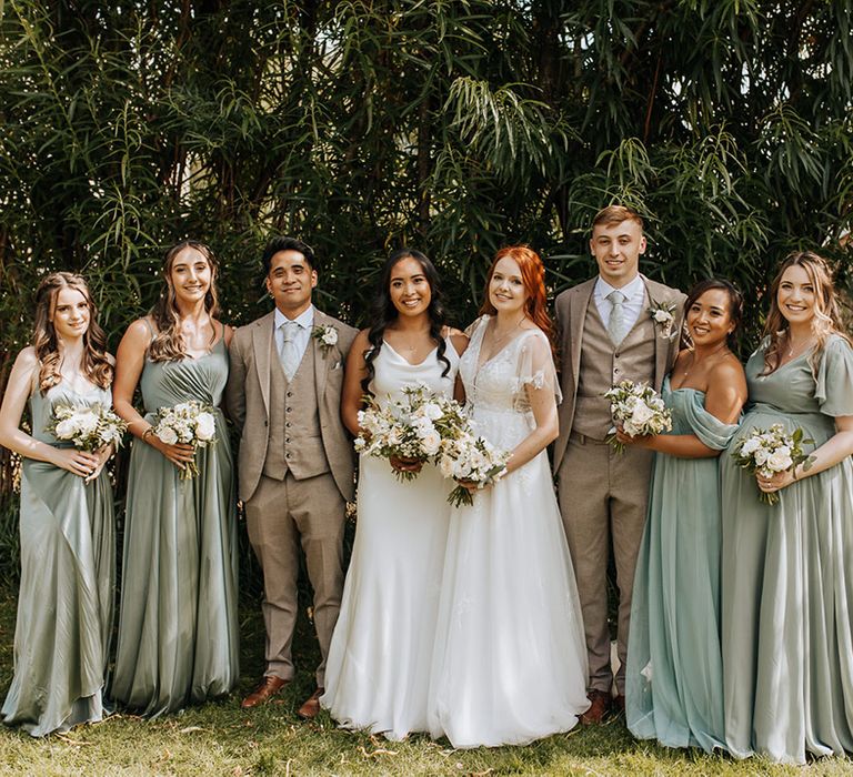 I Do Crew wearing green bridesmaid dresses from TH&TH and green suits 