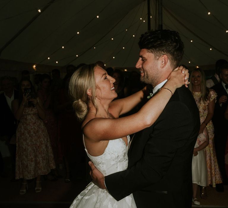 The bride and groom have their first dance together 