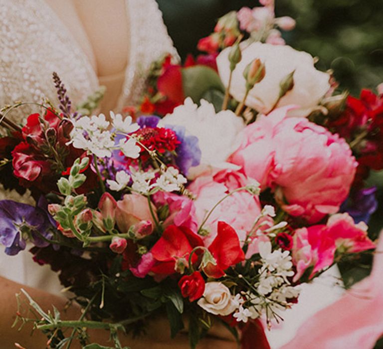 Bright pink wedding bouquet with peonies and roses for summer wedding 