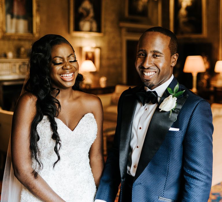 Groom in navy suit with black lapel and bride in a strapless wedding dress 