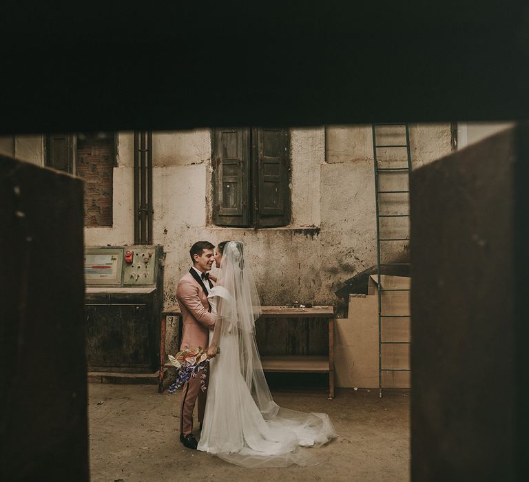 bride and groom portrait at industrial wedding venue 