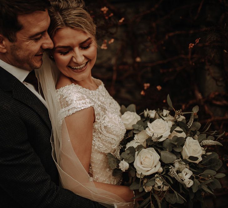 Happy couple on their wedding day with white winter wedding theme at Christmas