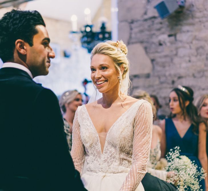 Bride and groom exchanging vows at The Great Tythe Barn civil ceremony 