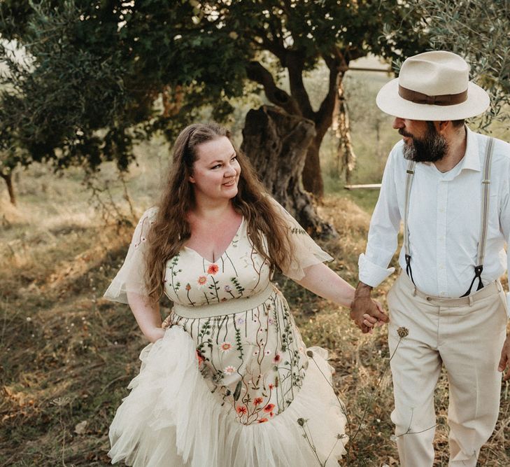 Bride wears floral embroidered wedding dress