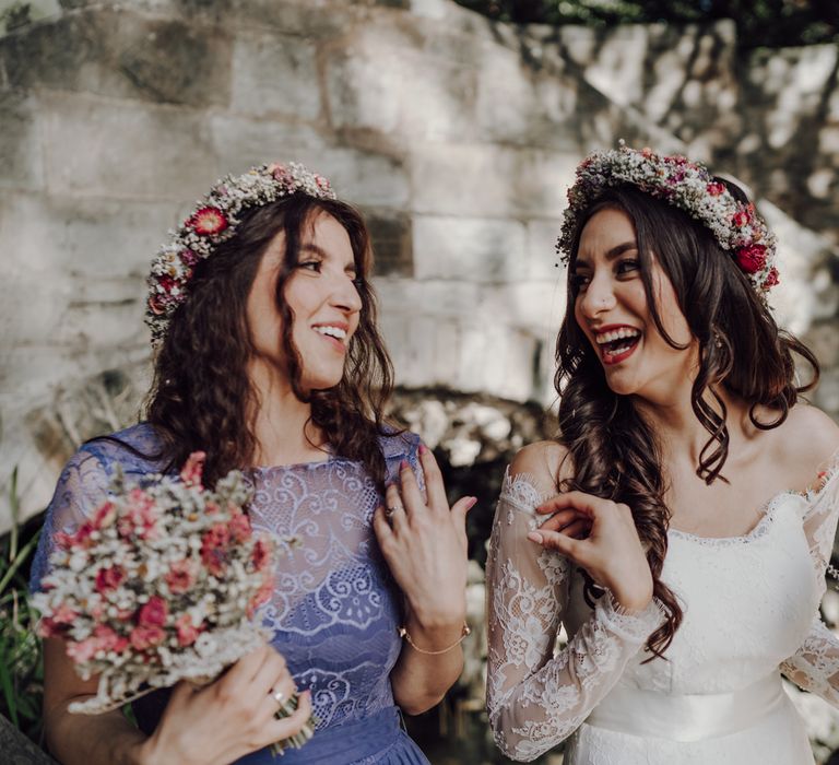 Bride laughs with her bridesmaid