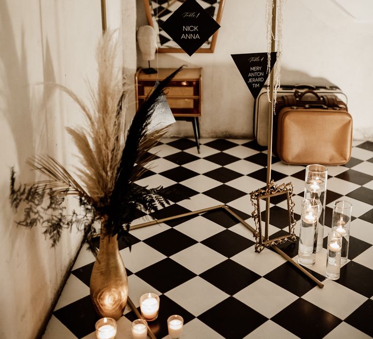 Black & white wedding decor with suspended table plan