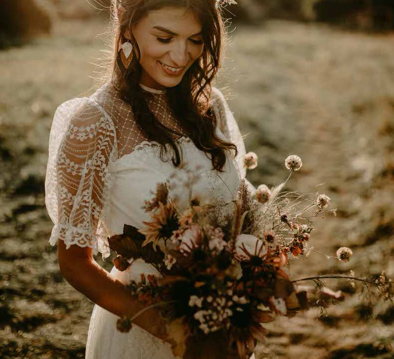 The bride holds her bouquet of sustainable, locally grown flowers