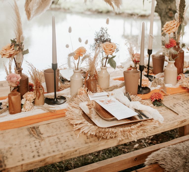 Boho chic outdoor table decor with Autumnal colour scheme and pampas grass arch 