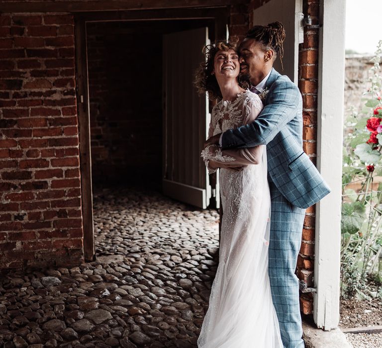 The couple embrace at Sedgewell Barn