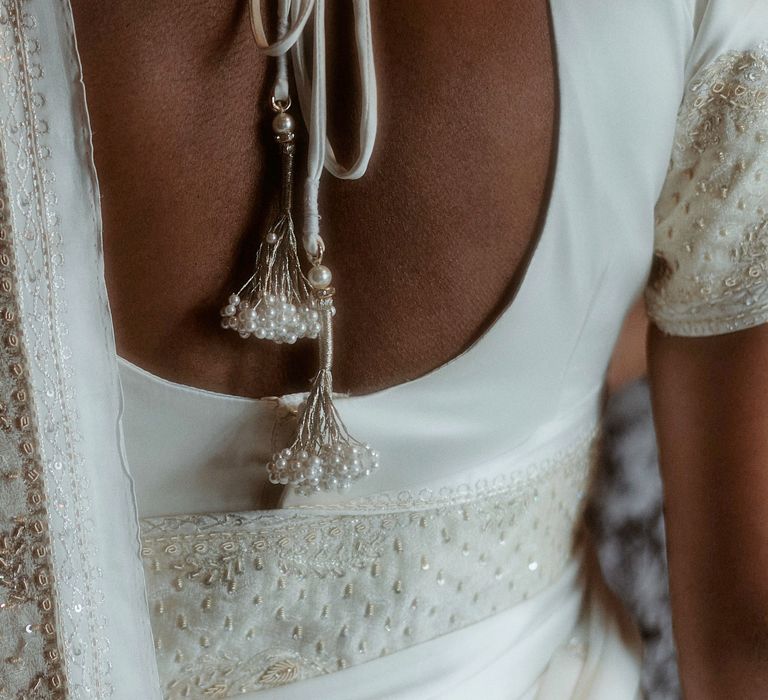 Beautiful embroidered detail on the brides white sari 