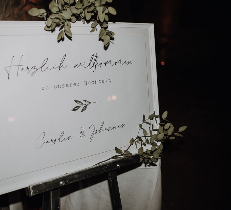 Elegant framed welcome sign with leaf details at rural German Wedding