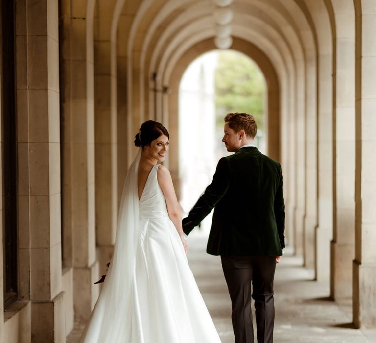 Bride and groom holding hands at Manchester hall wedding