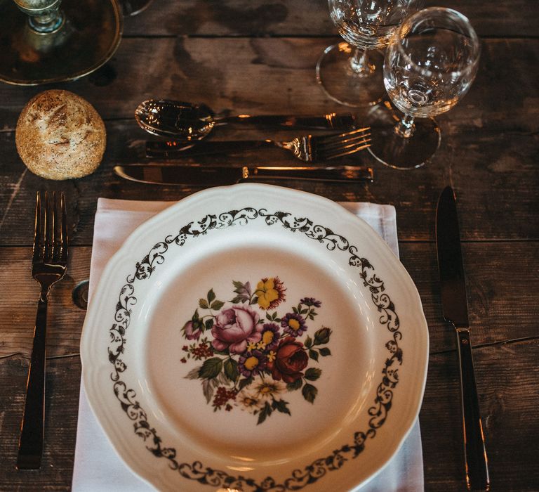 Place setting with white napkin and patterned tableware 