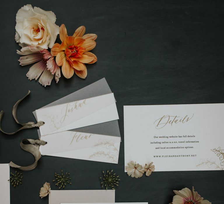 White and gold wedding stationery with slate grey ribbon detail