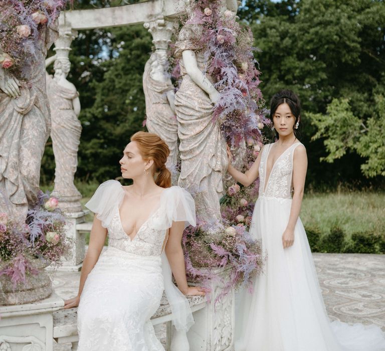 Brides together in front of bandstand surrounded by lilac florals in the Spring time