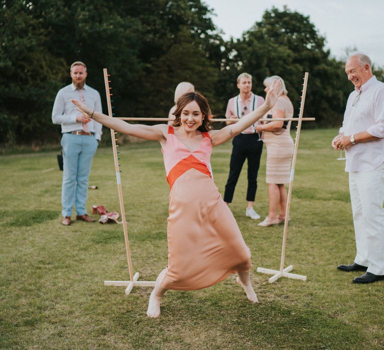 Bride plays on the lawn after changing into wedding reception dress