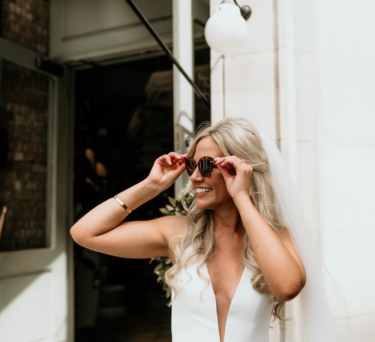 Bride wears sunglasses outside in London