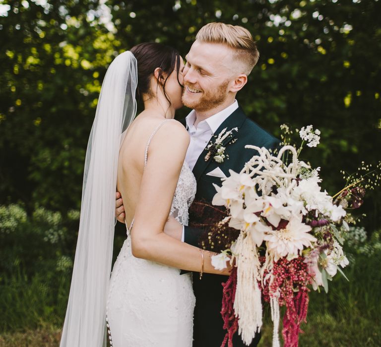 Bride & groom embrace on the day of their wedding