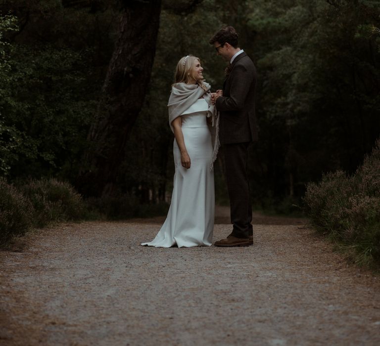 Bride & groom stand together during Scottish elopement 