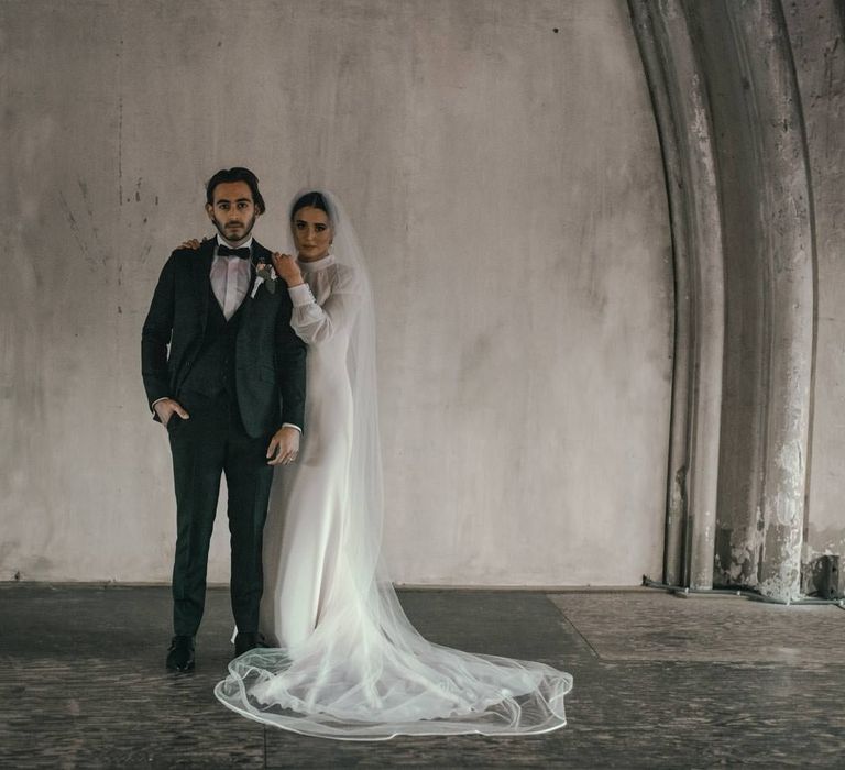 Bride & groom stand together on their wedding day for wedding photoshoot