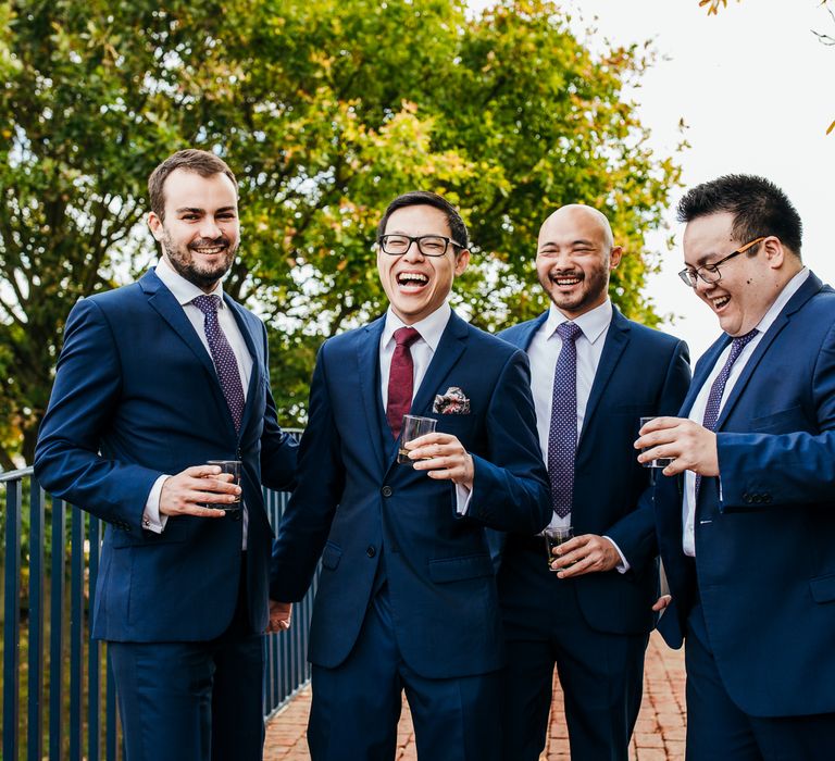 Groom stands with his Ushers on wedding day