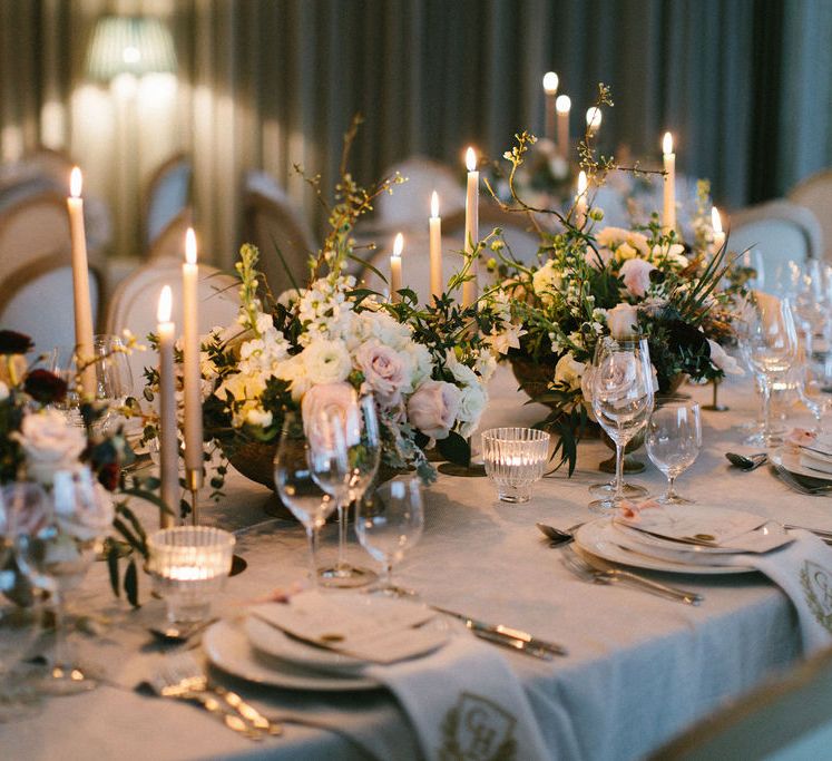 Elegant wedding table decor with grey taper candles and romantic flower centrepieces 