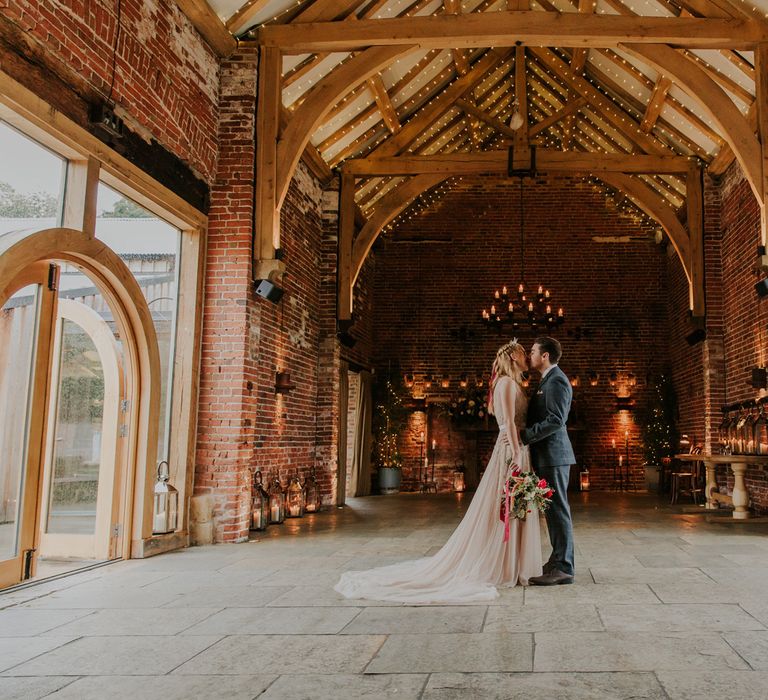 Fairy lit ceiling and candle chandelier at rustic wedding venue Hazel Gap Barn