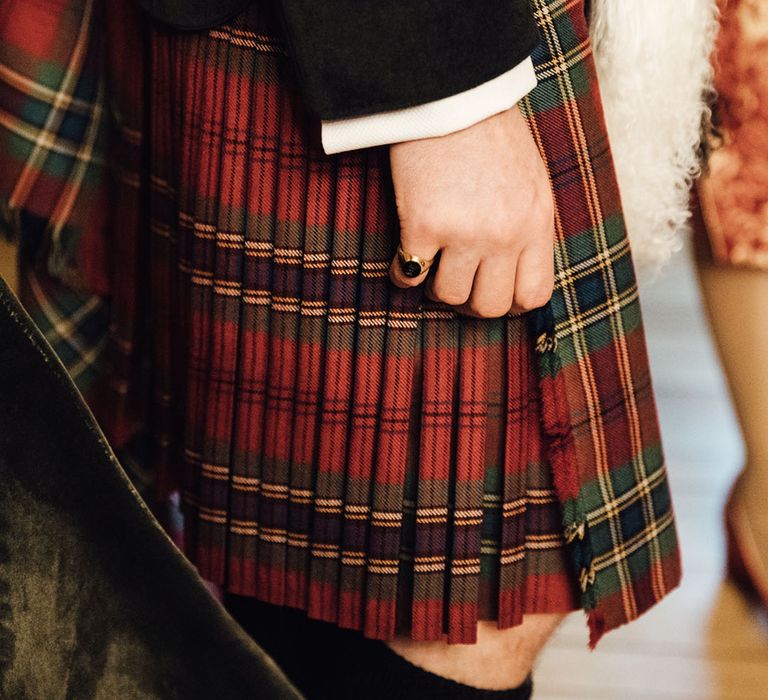 Red and green kilt for groom