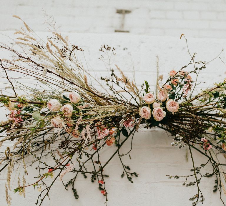 Twig, dried grasses and pink flower installation 