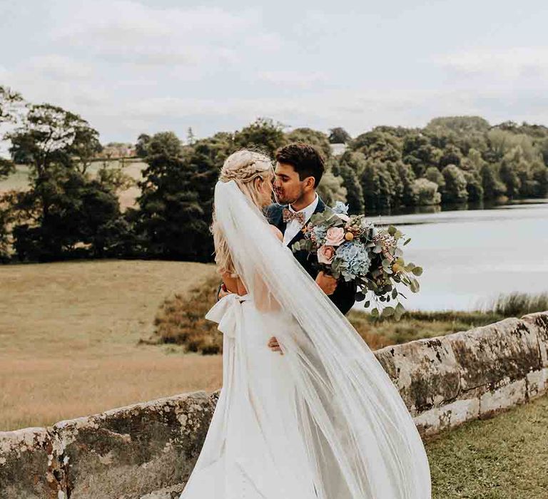 Bride in bow back wedding dress with groom