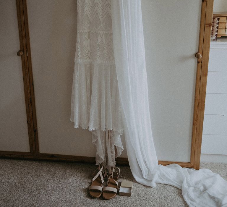 Grace Loves Lace Bardot wedding dress on hanger with veil and sandals before Isle of Wight wedding with macrame wedding decor