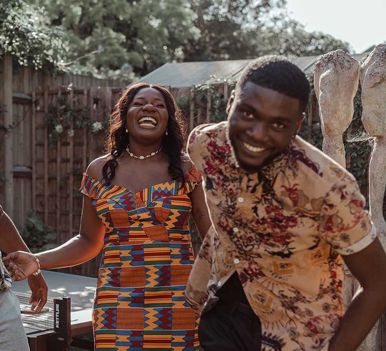 Bride laughs with wedding guest on her wedding day