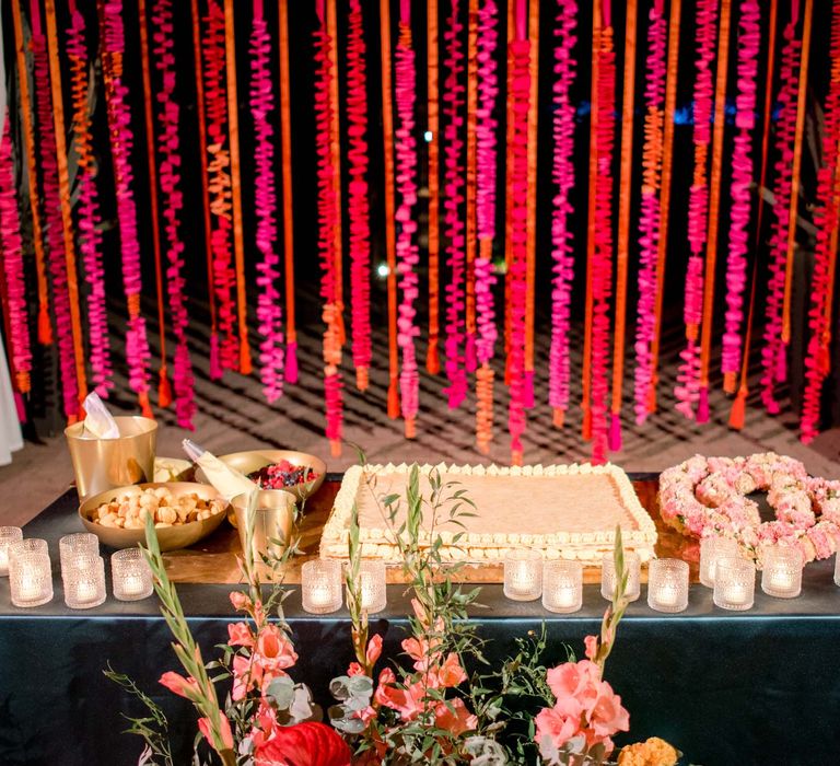 Wedding cake surrounded by colourful florals