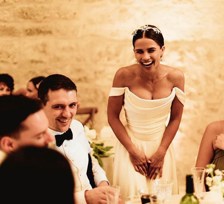 Bride laughs during wedding speeches