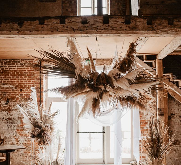 Godwick Barn complete with pampas grass installations and bright window behind