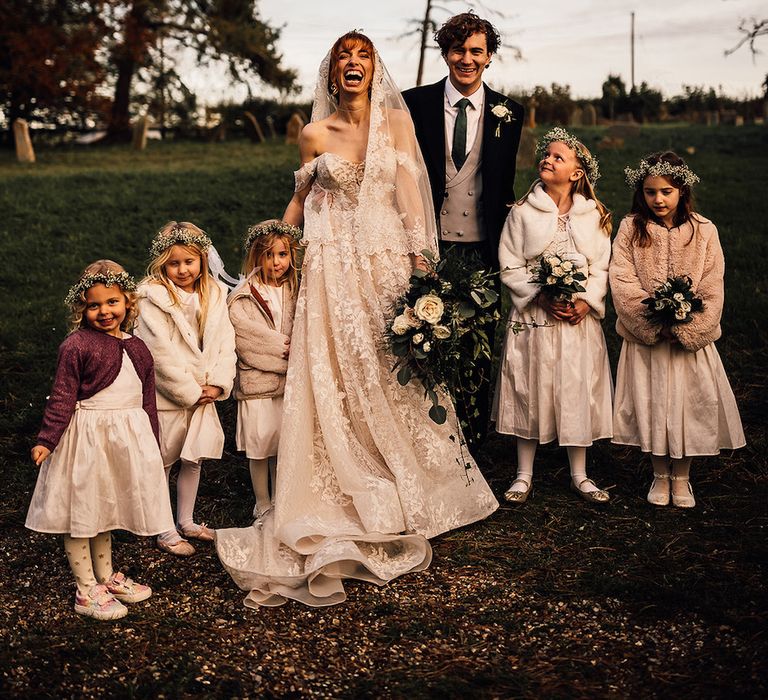 Bride and groom with their flower girls at winter wedding at Oxnead Hall