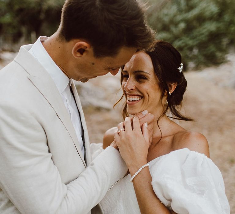 Bride and groom smile at each other 