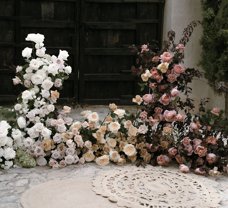 White, pink and orange roses for large flower display for the destination wedding altar style