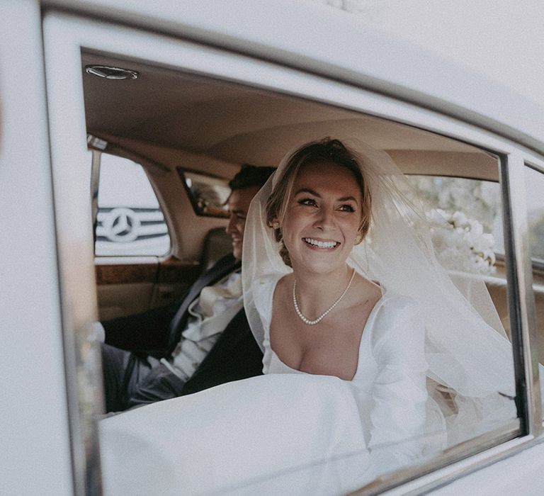 Bride in wedding car arriving at Hedsor House wedding 