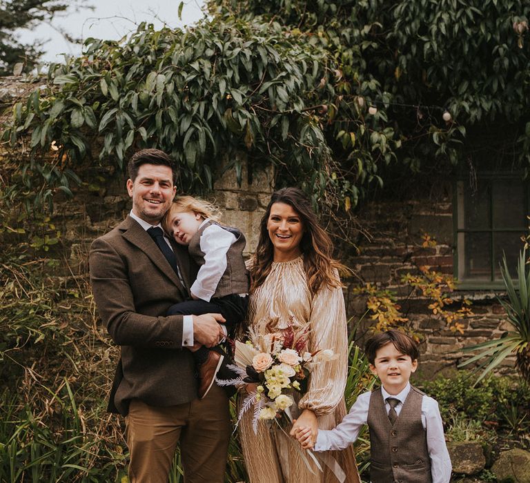 Wedding guests and their children pose together at Ash Barton Estate wedding venue