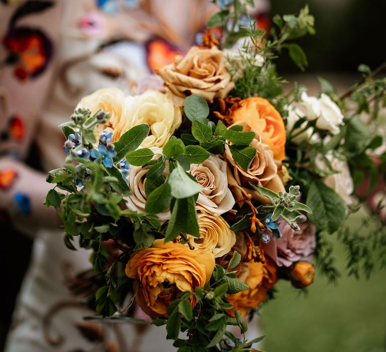 Orange, yellow, pink and blue wedding bouquet for colourful wedding 