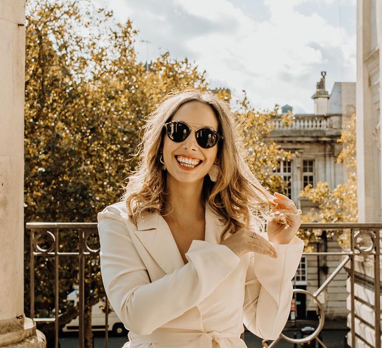 Bride in sunglasses and a trouser suit at Portsmouth Guildhall registry office wedding