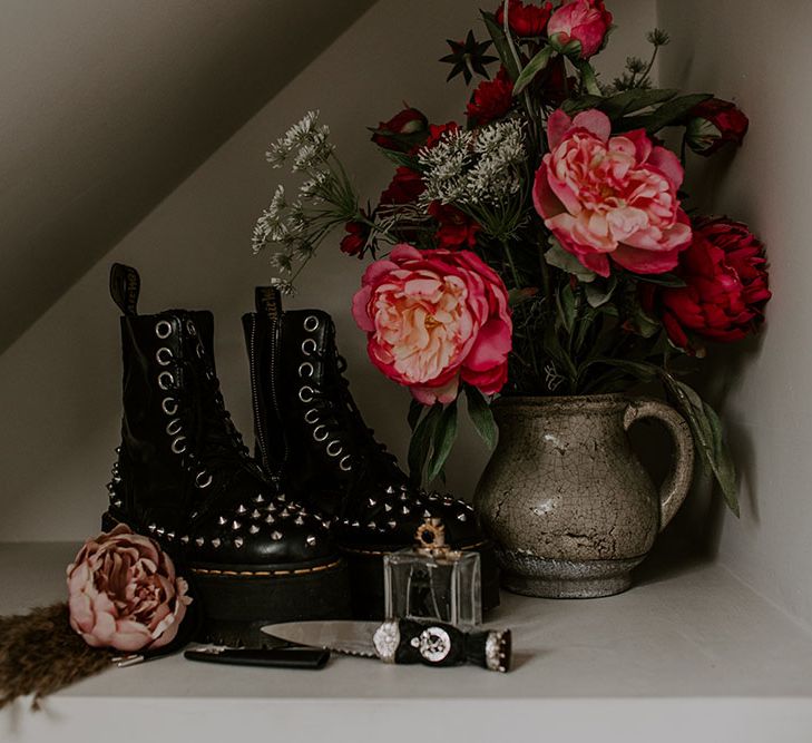 Dr Martens complete with platforms and studs next to flowers on wedding day 